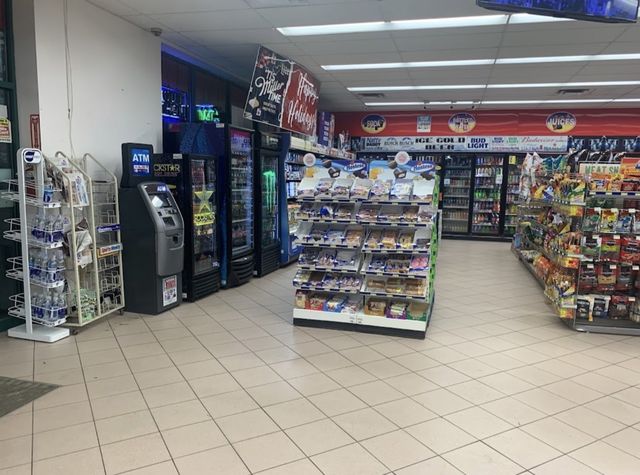 Inside One Dream with drink coolers, snacks, and store aisles
